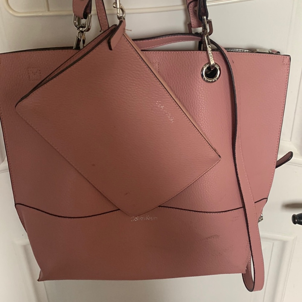 Pink Calvin Klein purse with its wristlet matching bag set.